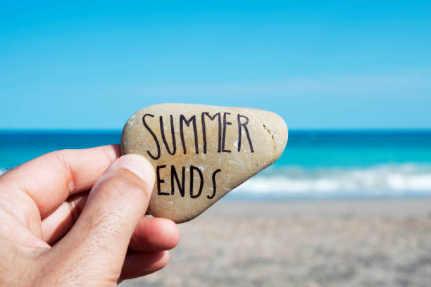 istock man on the beach and text summer ends in a stone 1018719056