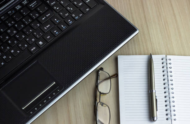 istock Office workplace with text space, White wooden table with office supplies tablet, desktop computer and book, top view, over light 1018719080