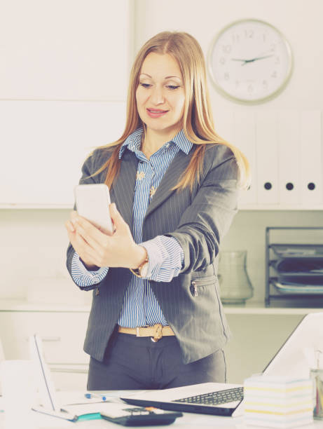 istock Businesswoman with cellphone in office 1018719186