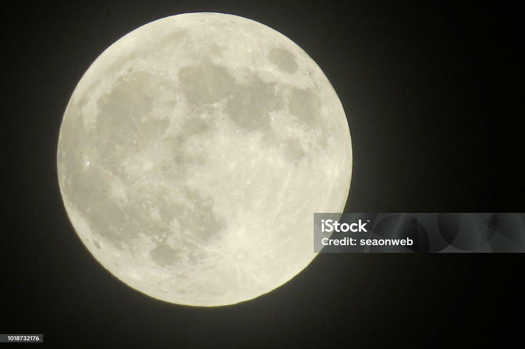 a  closeup of a full moon showing craters closeup of a full moon showing craters Full Moon Stock Photo