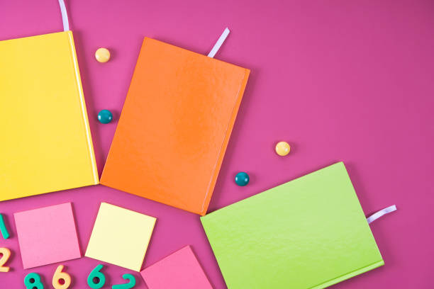 istock flat lay with colorful notebooks and appliances on pink 1018735744