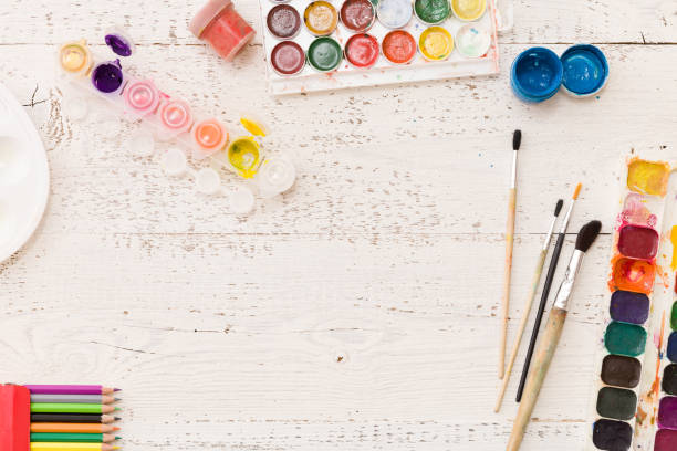 istock Top view on colorful paints and brushes. Creative ideas, creativity and early learning. Education concept. 1018736298