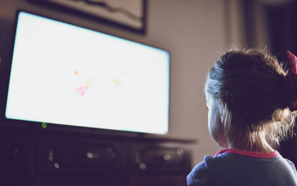 istock Little girl staring at TV 1018736356