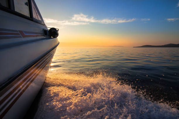 istock White motorboat moving fast to sunset 1018738448