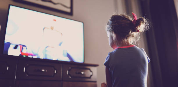 istock Little girl staring at TV 1018738456