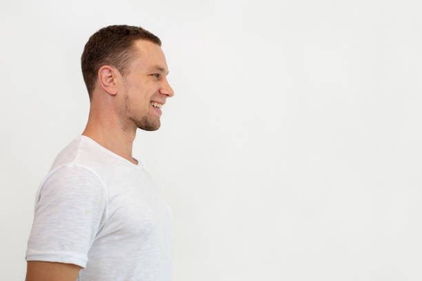 istock Cheerful excited ypung man standing against white wall 1018742918