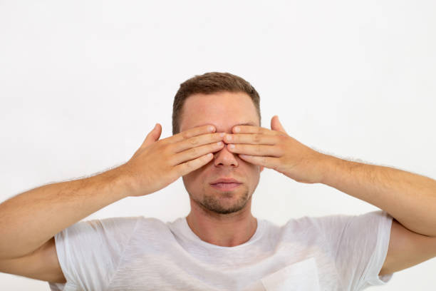 istock Serious young man covering eyes with hands 1018742934