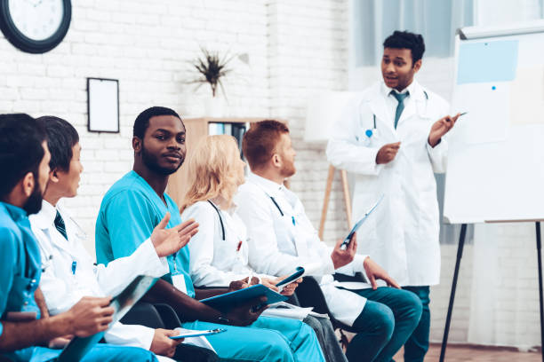 istock Black Doctor Camera Staring During The Lecture. 1018745826