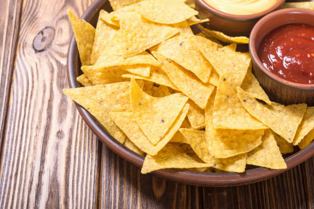 istock Crispy chips nachos with tomato and cheese sauce 1018746338