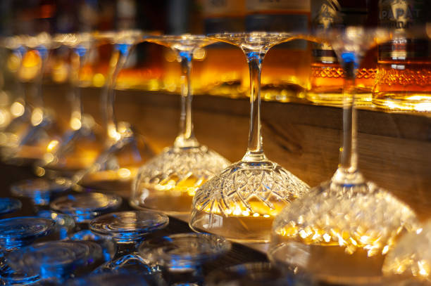 glass row bar counter . Many empty wineglasses glass row bar counter . Many empty wineglasses. Yellow warm light cafe transparent glass table stock pictures, royalty-free photos & images