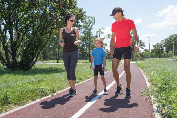 istock Young Family Running On Track 1018746966