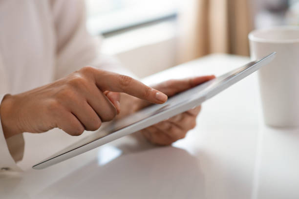 istock Cropped view of freelancer working with touchpad 1018747114
