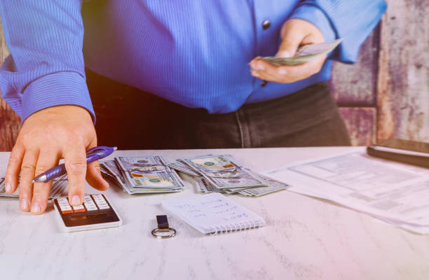 istock Businessman calculation and holding calculator analysis summary report 1018747272
