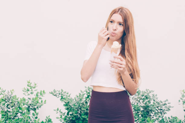 istock Dreamy girl eating ice cream with spoon 1018751762