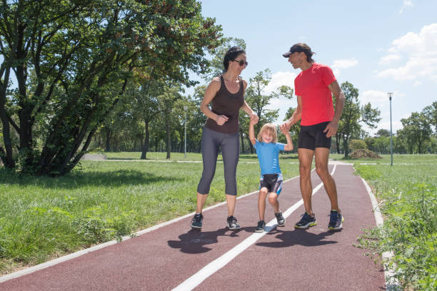 istock Father and mother with their son running on the track 1018751820