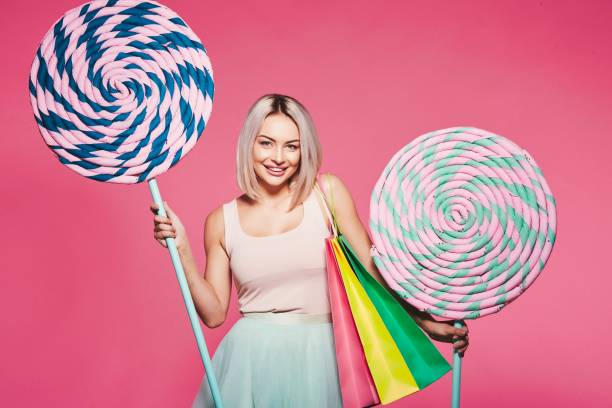 istock Cute model with sweets and shopping bags 1018751892