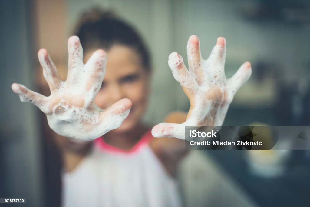Cleanliness is half the health. Hands of a little girl of foam. Close up. Copy space. Focus is on hands. Washing Hands Stock Photo