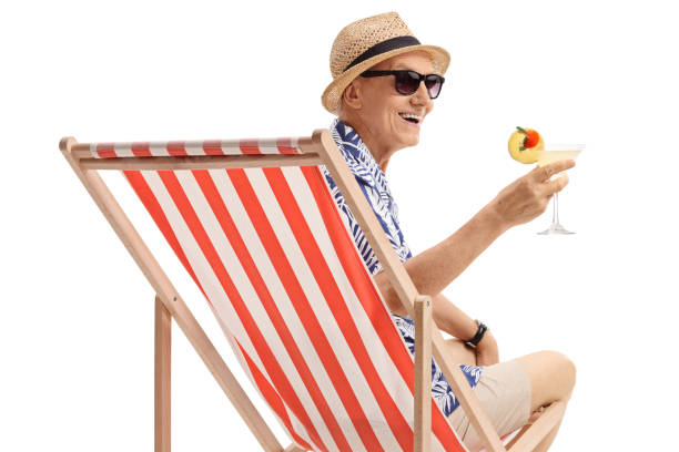 istock Elderly tourist with a cocktail sitting in a deck chair 1018758182