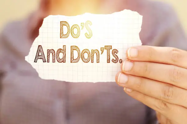 Photo of business woman holding tear paper with do's and don'ts ? text