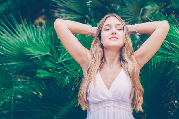 istock Peaceful young woman relaxing in tropical forest 1018764456