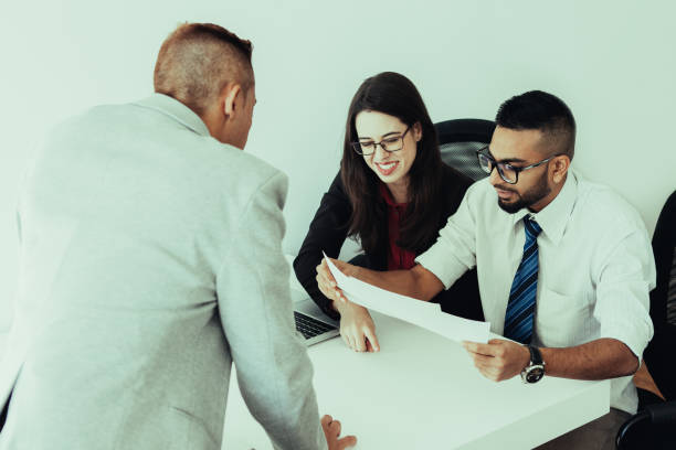 istock Cheerful financiers examining business documents 1018771014