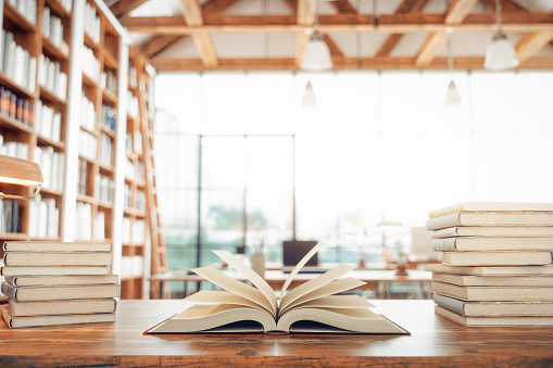 Old books on the desk in a library.