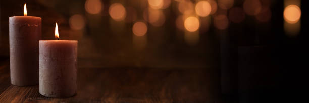 istock Burning candles with festive golden bokeh 1018774038