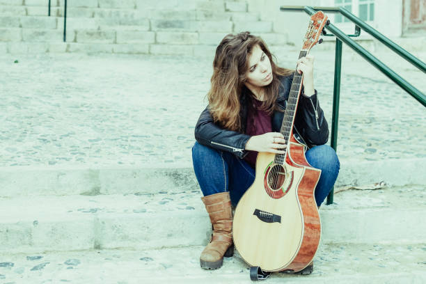 istock Focused Woman with Guitar Picking Song 1018779514