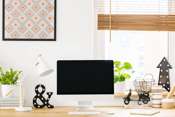 istock Monitor screen on the wooden desk in home office 1018787930