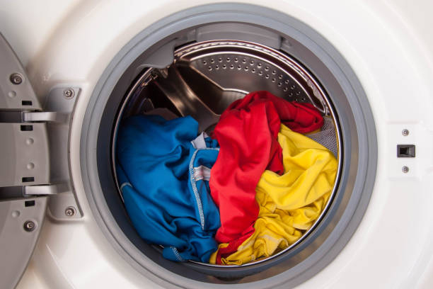 istock Washing machine full of dirty clothes. 1018797878