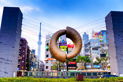 Tokyo Japan - April 4, 2018 : Kinshicho station, golden sculpture train station has become a landmark for tourists and people to remember. this back high famous building is Skytree tower.