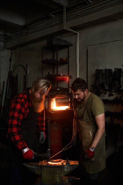 istock Blacksmith showing how to shape metal 1018801098