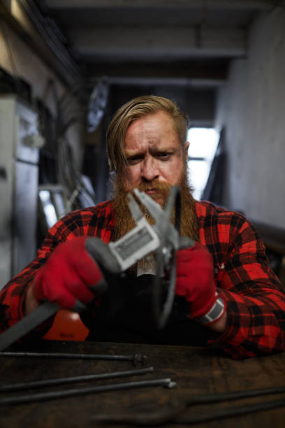 istock Frowning worker measuring steel detail 1018801258