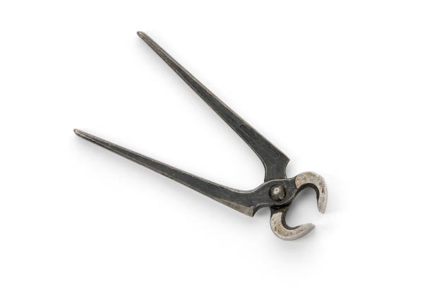 Close up of old metallic pliers on wooden table