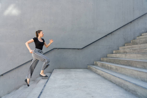 istock Woman running up steps in urban setting 1018802084