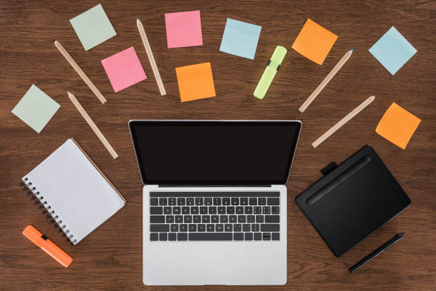 istock top view of workplace with arranged textbooks, post it and laptop with blank screen 1018805080