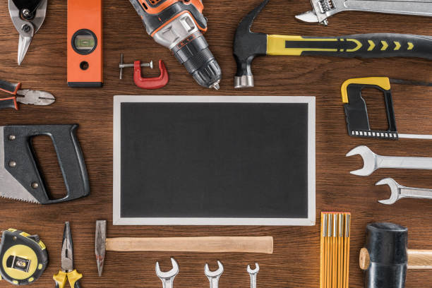 istock top view of empty blackboard near arranged various tools on wooden table 1018805240