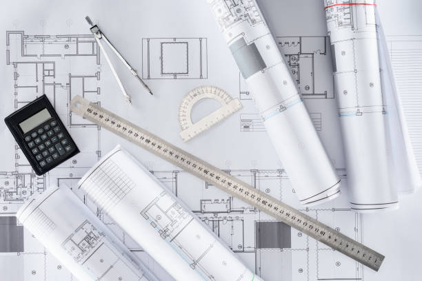istock top view of architect blueprints, ruler, protractor, calculator and divider 1018805250
