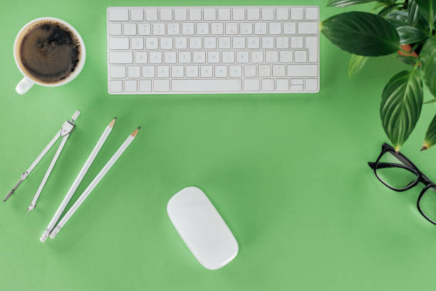 istock top view of architect workplace with divider, pencils, coffee and plant on green table 1018805334