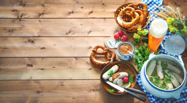 Bavarian sausages with pretzels, sweet mustard and beer on rustic wooden table Bavarian sausages with pretzels, sweet mustard and beer on rustic wooden table. Beer Fest menu weisswurst photos stock pictures, royalty-free photos & images