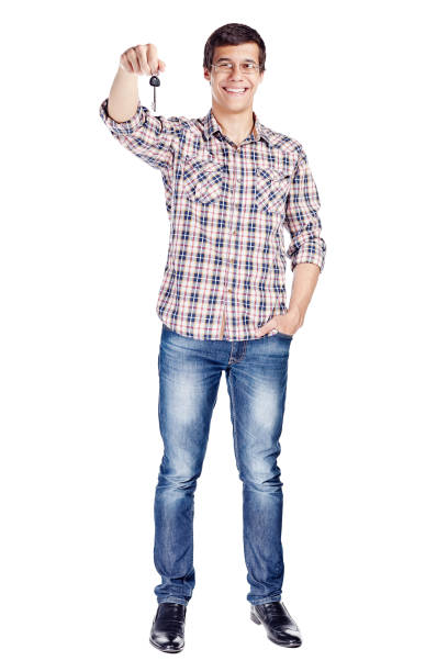 istock Man showing key full body 1018810948