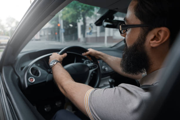 istock Modern casual bearded man driving a car 1018811554