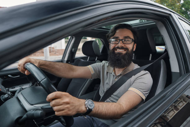 istock Happy car driver with fastened seat belt 1018811556