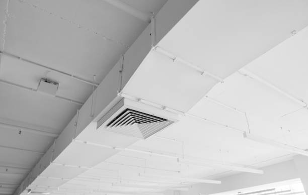 istock Ventilation system on the ceiling of large buildings. Ventilation pipes in silver insulation material hanging from the ceiling inside new building. 1018812396