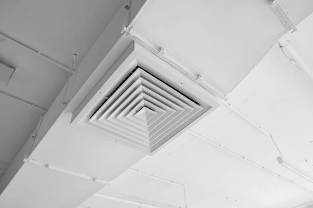 istock Ventilation system on the ceiling of large buildings. Ventilation pipes in silver insulation material hanging from the ceiling inside new building. 1018812536