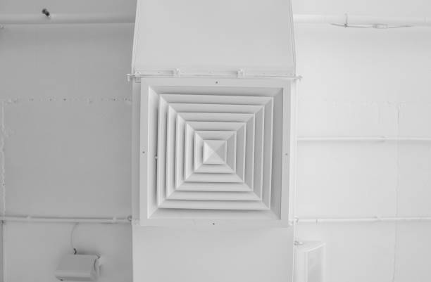 istock Ventilation system on the ceiling of large buildings. Ventilation pipes in silver insulation material hanging from the ceiling inside new building. 1018812680