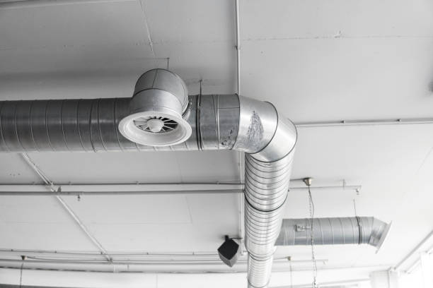 istock Ventilation system on the ceiling of large buildings. Ventilation pipes in silver insulation material hanging from the ceiling inside new building. 1018812828