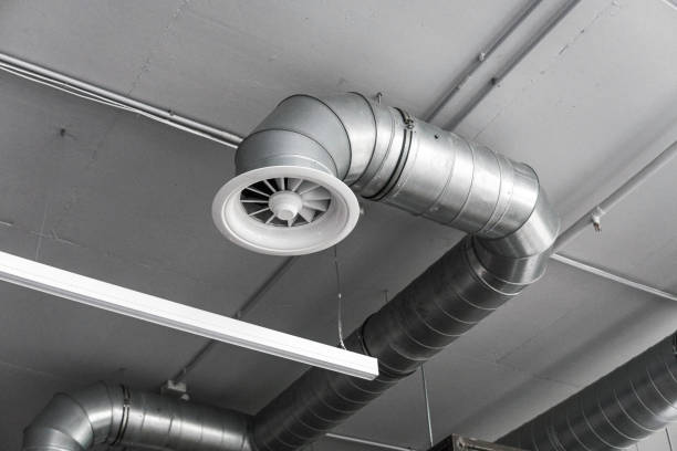 istock Ventilation system on the ceiling of large buildings. Ventilation pipes in silver insulation material hanging from the ceiling inside new building. 1018816982
