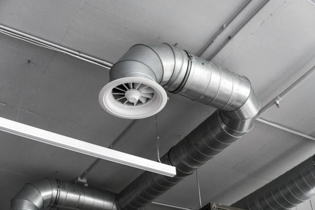Ventilation system on the ceiling of large buildings. Ventilation pipes in silver insulation material hanging from the ceiling inside new building. stock photo