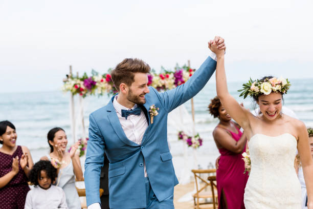 Cheerful newlyweds at beach wedding ceremnoy Cheerful newlyweds at beach wedding ceremnoy altar photos stock pictures, royalty-free photos & images